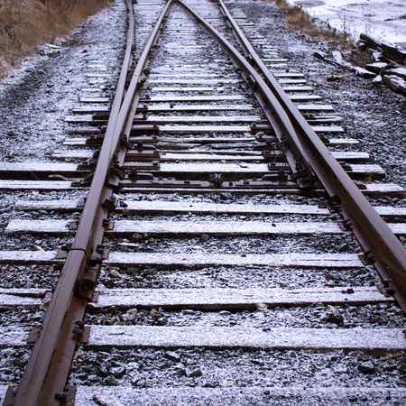 First snow of the year melting on contact on train tracksの写真素材