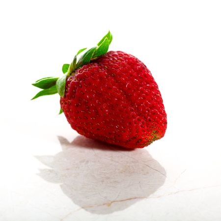 Delicious strawberry isolated on white with a marble base in high keyの写真素材