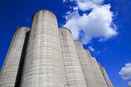 Concrete silos against a deep blue skyの写真素材