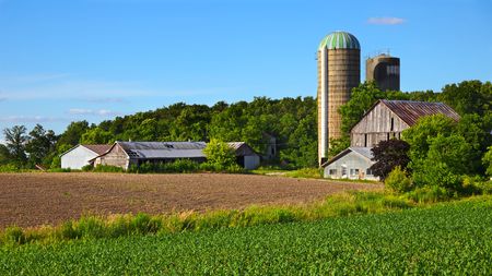 Older farm and field in springの写真素材