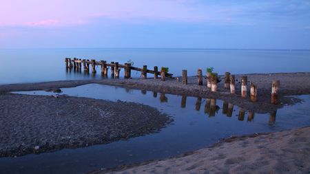 Pier, tidepool and Lake Ontario in eveningの写真素材