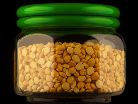 Glass container of chana dal isolated on blackの写真素材