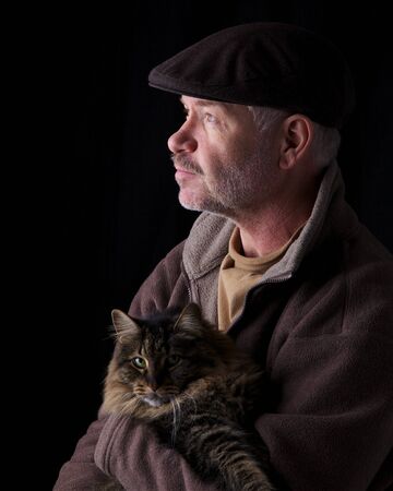 Older gentleman holding his catの写真素材