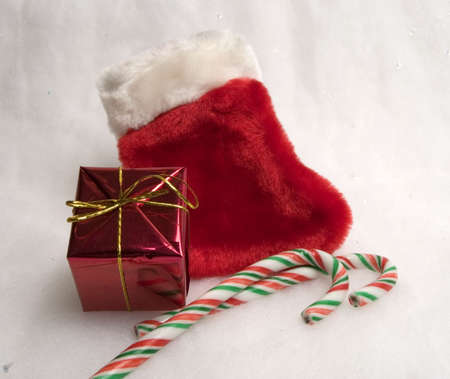 Classic christmas red stocking with little gift box and two candycanes