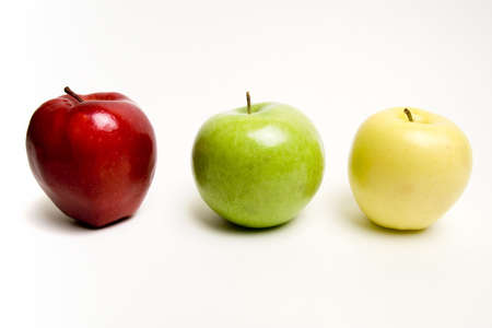 Red green and yellow apples in a rowの写真素材