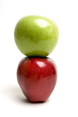 Green apple on top of the red oneの写真素材