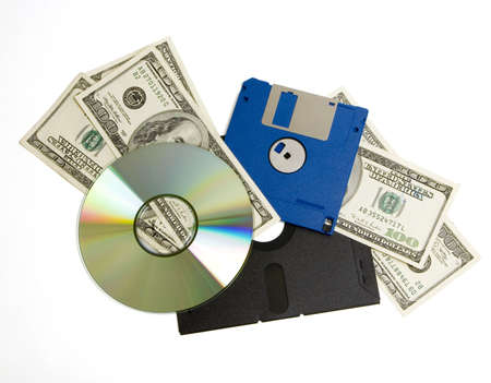From really old floppy discs to newer diskettes to CD, with 100 dollar bills layered in between. Represents high upgrade costs (isolated, clipping path)の写真素材