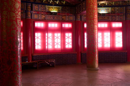 Beautiful room inside Chinese palace with windows that glow with diffused sunlightの写真素材