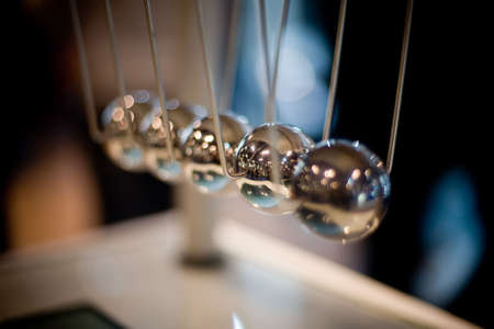 Macro shot of newton's cradle with shallow depth of field (only second ball is in focus)の写真素材