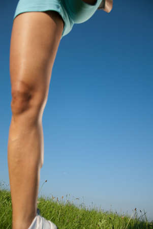 young woman jumps while running in her spare time in the natureの写真素材