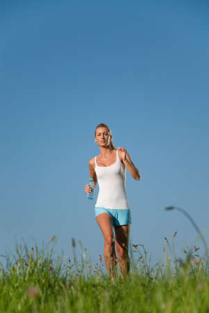 young woman running in her spare time in the natureの写真素材