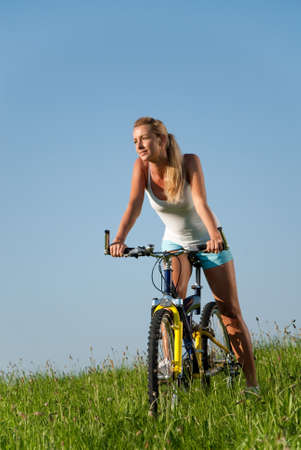 young woman cycling in her spare timeの写真素材