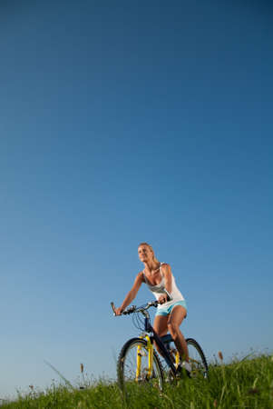young woman mountainbiking in her spare timeの写真素材