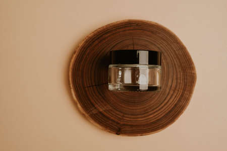 Glass jar on wooden round sliceの写真素材