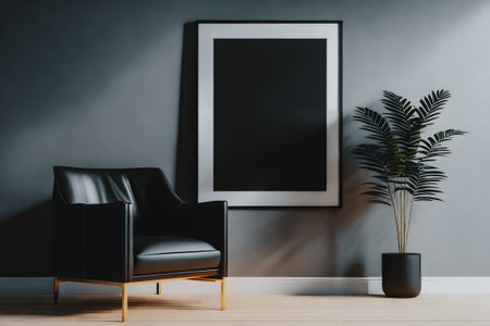 Dark interior with black armchair, plant, wooden floor and empty poster in frame with copy space on gray wall. Generative AI.の素材