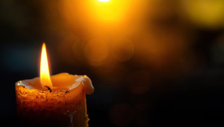Black background with candle flameの素材