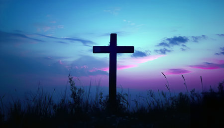 Tranquil sunset with silhouette of a cross symbolizing faith and spiritualityの素材
