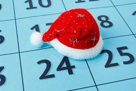 Red cap of Santa Claus on the calendar with the numbersの写真素材