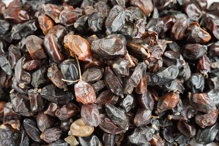 Black dry barberry close-up composition of individual berries