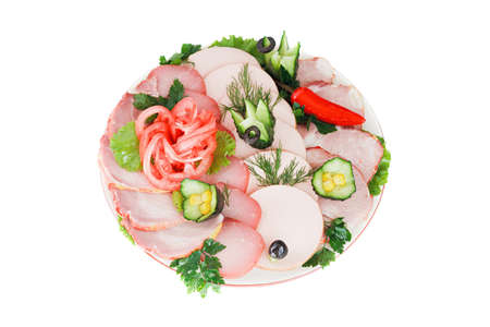 Assorted meat on a plate with vegetables and spicesの写真素材
