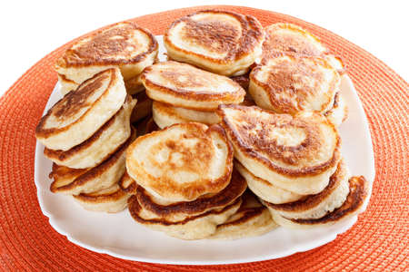 stack of domestic, lush flapjacks on a white plate closeup