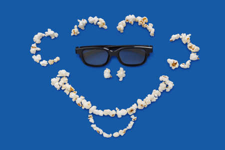 three-dimensional 3d technology conceptual photo of smiling face on a blue backgroundの写真素材