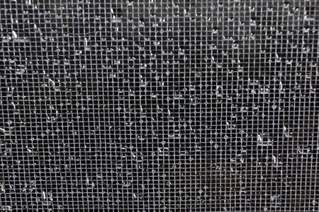 Detail Fishnet or mosquito netting. Rain drops