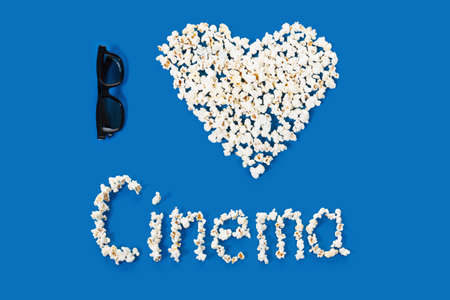 three-dimensional 3d technology conceptual photo of symbol, heart shape. with the inscription letters cinema on a blue backgroundの写真素材