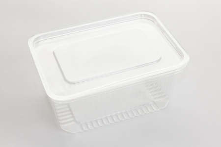 Empty transparent plastic storage box of food on white