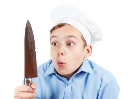 Young chef really surprised failure with a knife. Isolated on whiteの写真素材