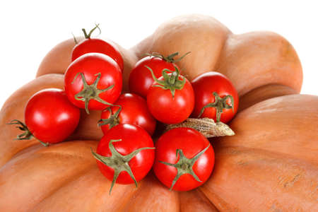 Bunch of ripe red tomatoes and pumpkin isolated on a white background. Suitable for harvestの写真素材