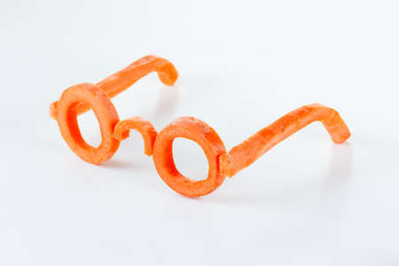 Concept glasses of carrot carotene benefits for vision. Proper nutrition improves vision.の写真素材