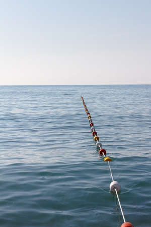 buoy rope barrier on the water with variegated floatsの写真素材