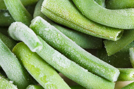 Frozen green beans background. Stocks for the winter, ice and snow. It can be used as background....