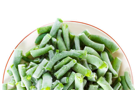 Green frozen beans on the plate for long time storage, ice and snow Stocks for the winter. Isolated...