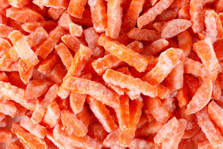 Group of sliced frozen carrots, isolated on white, ice and snow. It can be used as background. Macro...