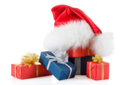 Red santa hat with gifts isolated on white backgroundの写真素材