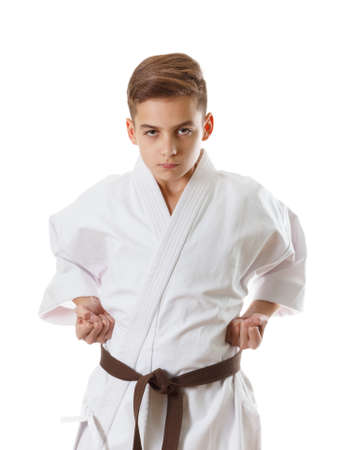 Martial art sport - child teen boy in white kimono training karate punch and blockの写真素材