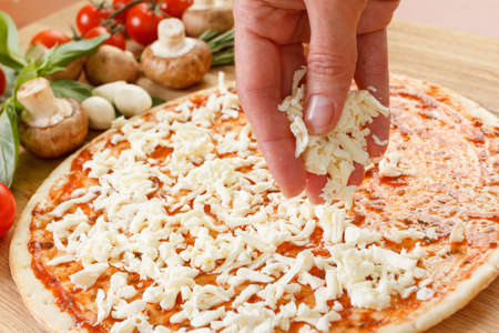 Food ingredients for pizza on table close up. Cooking homemade pizza with fresh vegetablesの写真素材