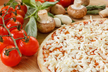 Food ingredients for pizza on table close up. Cooking homemade pizza with fresh vegetablesの写真素材