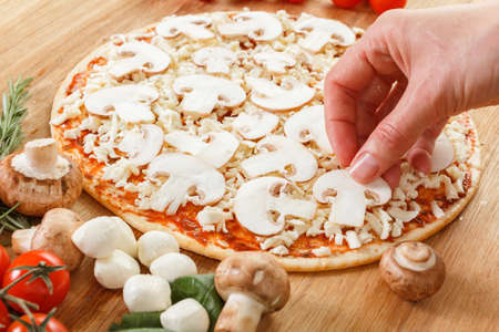 Cooking pizza with fresh vegetables. Food ingredients for pizza on table close up.の写真素材