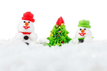 Homemade christmas sweet dessert snowman, snow and Christmas tree with festive decoration. Isolated on white backgroundの写真素材