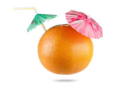 Concept Diet and healthy eating. Grapefruit with drinking straw and umbrella  isolated on whiteの写真素材