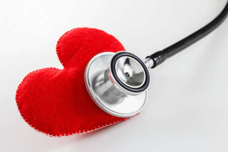Red heart and a stethoscope. Healthcare and Medicine concept studio shot. On white background.の写真素材
