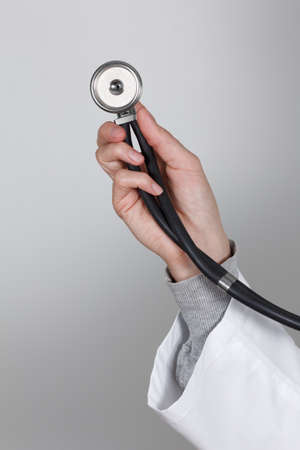 Hand of Doctor with stethoscope,medical uniforms, on white background. Closeup.の写真素材