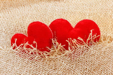 Two hearts symbol of love on the background of burlap. Wedding conceptの写真素材