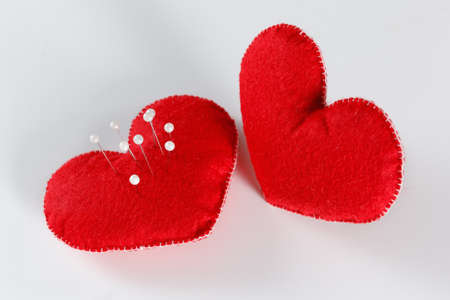 Red soft felt hearts isolated on white background. Symbol of love or datingの写真素材