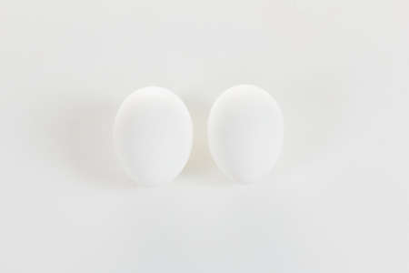 Two chicken eggs top view on a white backgroundの写真素材