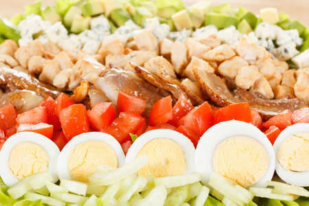 Traditional American Cobb Salad - Colorful entree  salad with bacon, chicken, eggs and tomatoes. Closeup as backgroundの写真素材