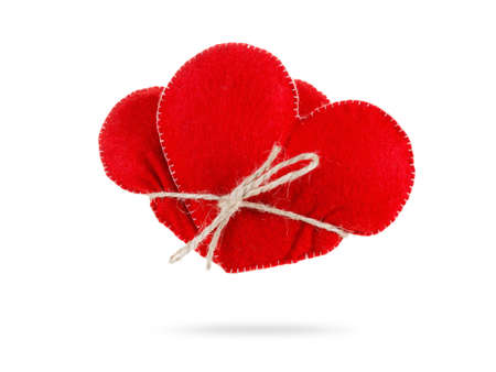 Two hearts together tightly bound with rope, concept of love and marriage. Isolated on white...